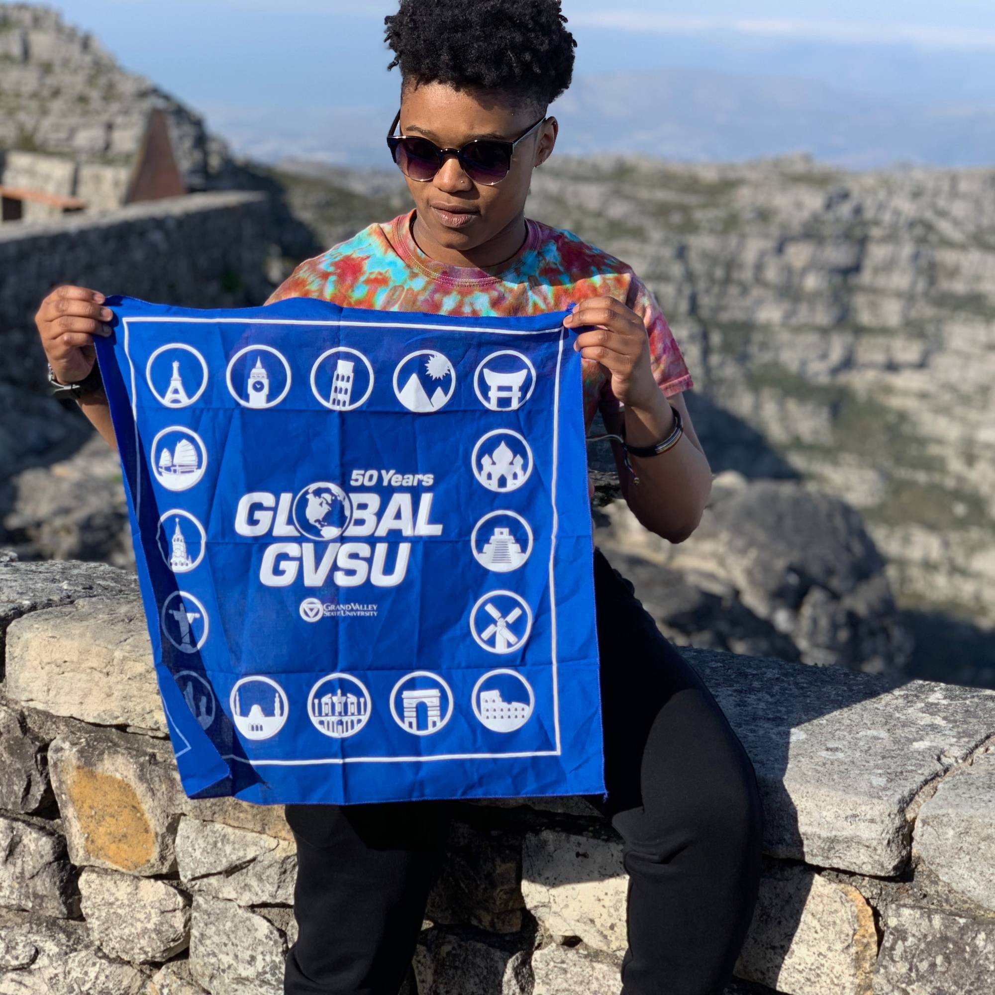 people swimming in natural pool in front of waterfall